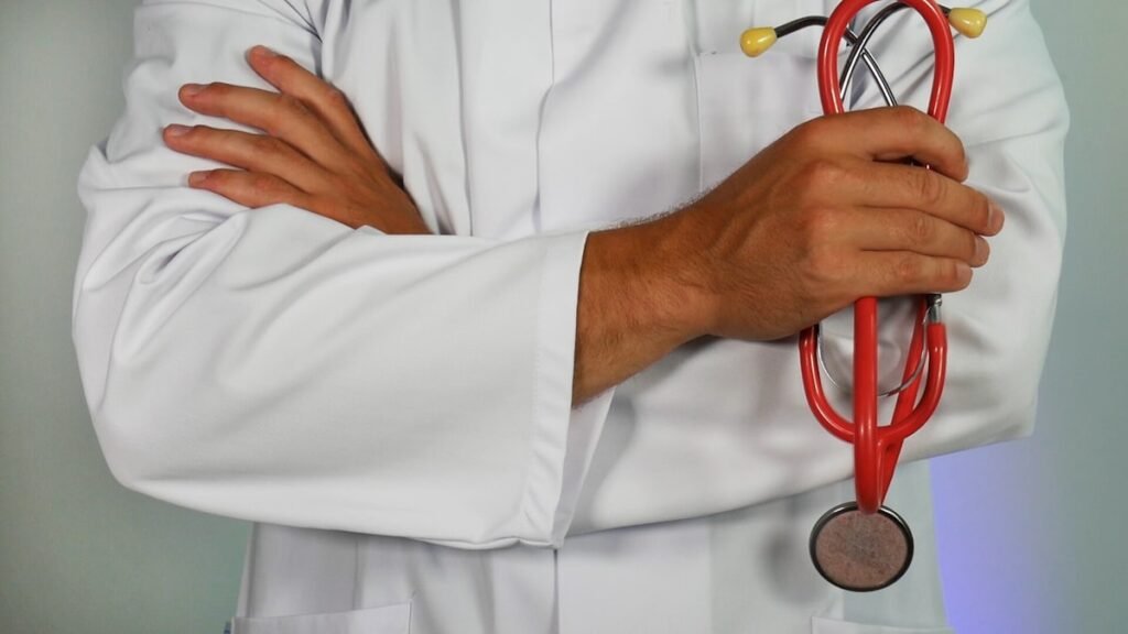 Medical aspirant studying with NEET preparation books and stethoscope for Re-NEET 2026