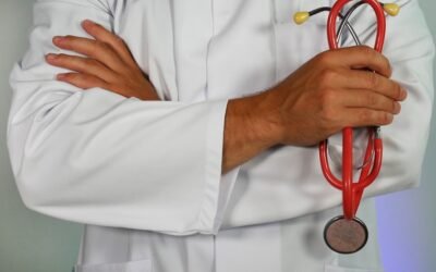 Medical aspirant studying with NEET preparation books and stethoscope for Re-NEET 2026