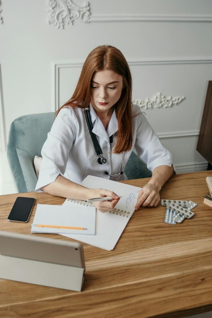 Medical student studying NEET books at a desk with stationery